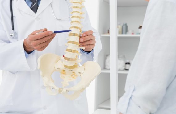 Doctor Explaining The Spine To Patient-Henry Chiropractic - 1602 N 9th Ave Pensacola, FL 32503 United States - (850) 435-7777